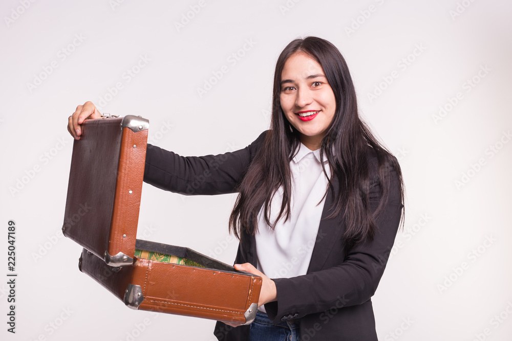Happy asian brunette woman opening retro suitcase on white background Happy asian brunette woman opening retro suitcase on white background