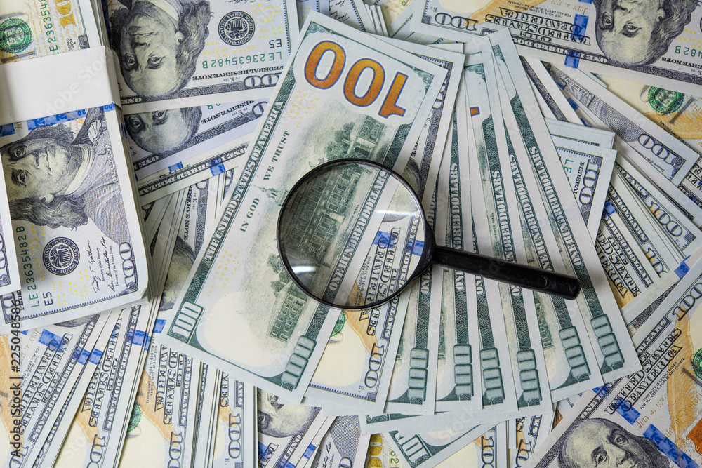 Business plan on financial income, dollar and business diagrams on financial reports with coins and magnifying glass. Work and profit Business plan on financial income, dollar and business diagrams on financial reports with coins and magnifying glass. Work and profit