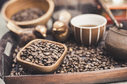 Coffee beans in a wooden Bowl on the wooden floor.