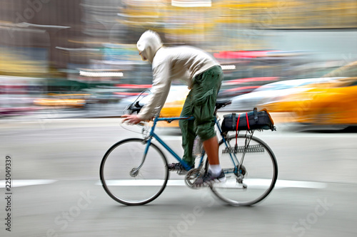 cyclist in traffic on the city roadway  motion blur