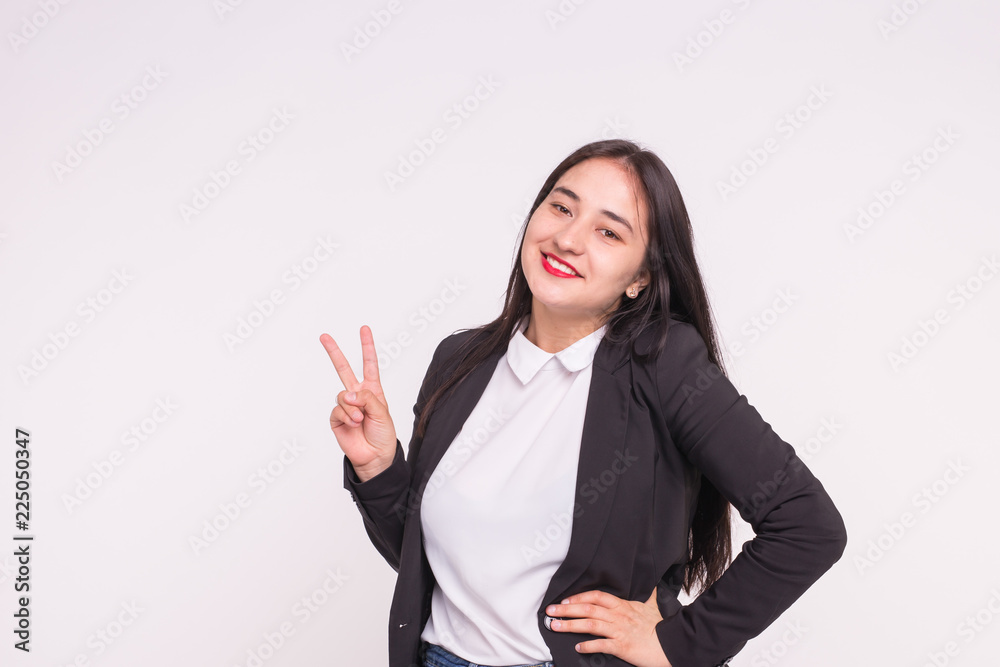 Beautiful young asian woman showing Victory Sign on white background with copy space Beautiful young asian woman showing Victory Sign on white background with copy space