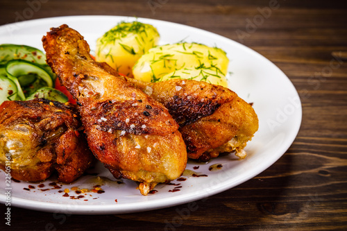 Grilled chicken drumsticks with boiled potatoes and vegetables