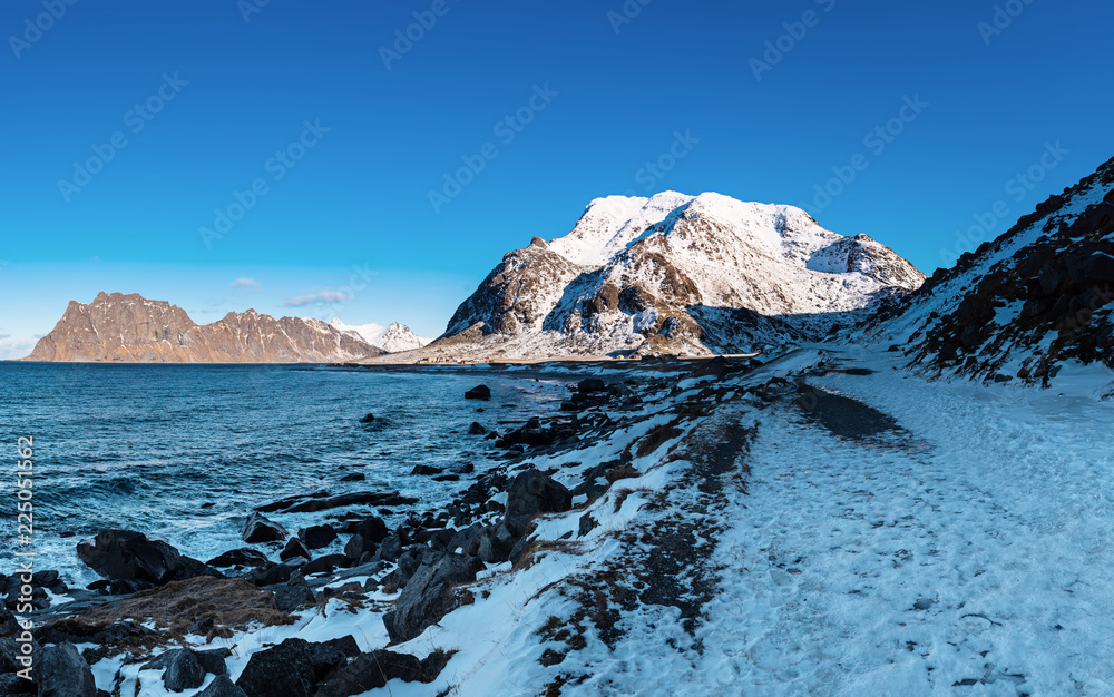 Scenic view of beautiful winter sea scandinavian landscape with blue sky, mountains and snow at Lofoten Islands in Northern Norway Scenic view of beautiful winter sea scandinavian landscape with blue sky, mountains and snow at Lofoten Islands in Northern Norway