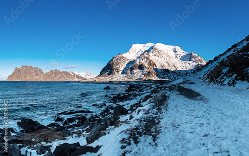 Scenic view of beautiful winter sea scandinavian landscape with blue sky, mountains and snow at Lofoten Islands in Northern Norway