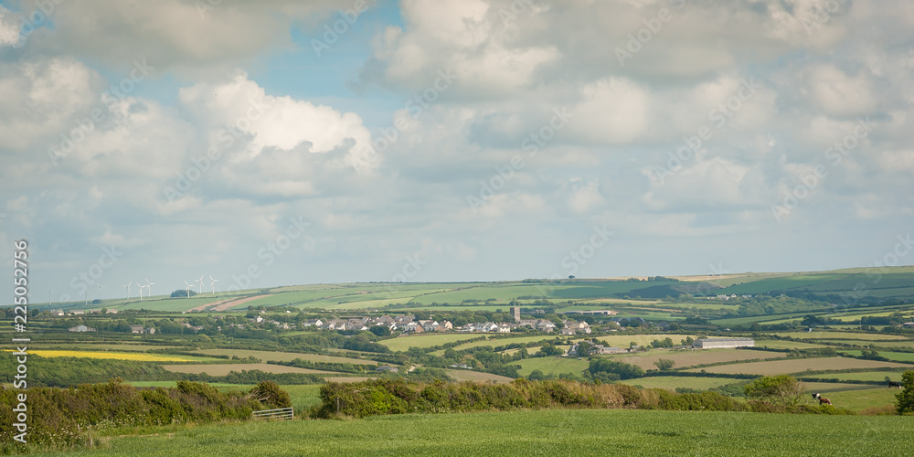 Obraz premium Panorama of traditional village in Cornwall, England in summer with cornfields 