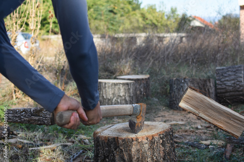 Wallpaper Mural Lumberjack chopping wood for winter, Young man chopping woods with old ax Torontodigital.ca