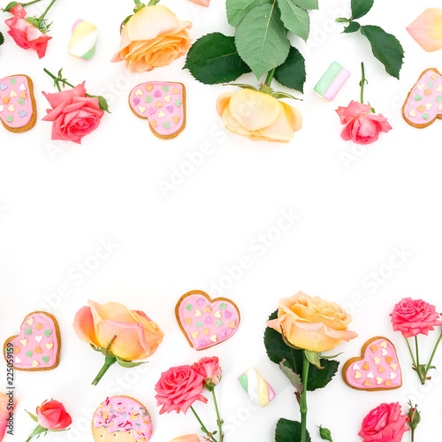 Fototapeta Naklejka Na Ścianę i Meble -  Frame made of roses flowers and petals with cookies and marshmallow on white background. Flat lay
