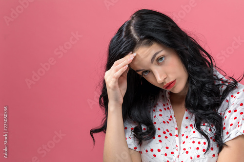 Εκτύπωση καμβά Young woman suffering from headache on a solid background