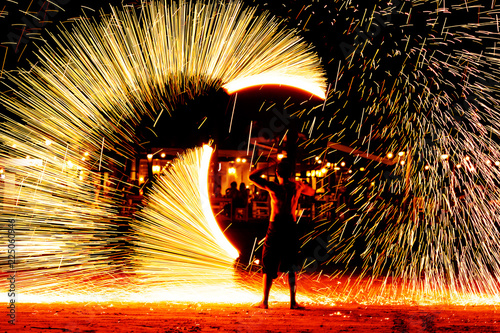 fire dance on beach near the sea , the east coast of thailand