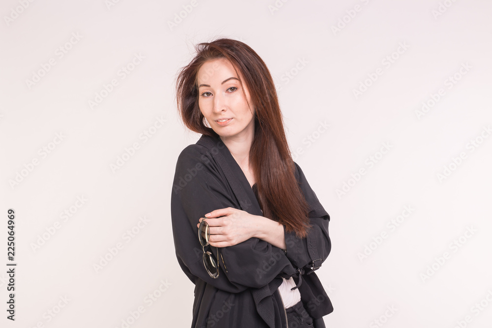 Portrait of fashionable beautiful asian woman in black over white background Portrait of fashionable beautiful asian woman in black over white background