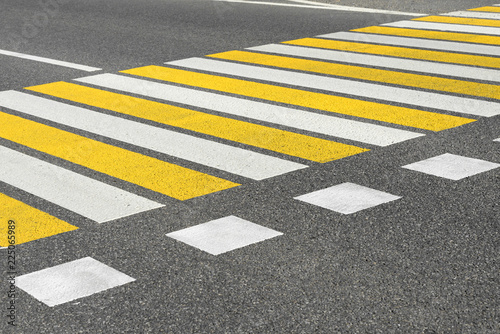 Asphalt road crosswalk with marking lines white and yellow stripes