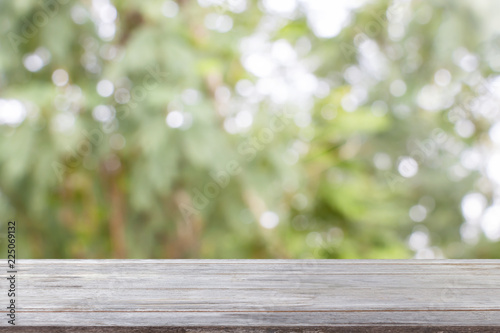 Wooden shelf template isolated on the green nature background. For decorated interior or montage of your product on shelf.