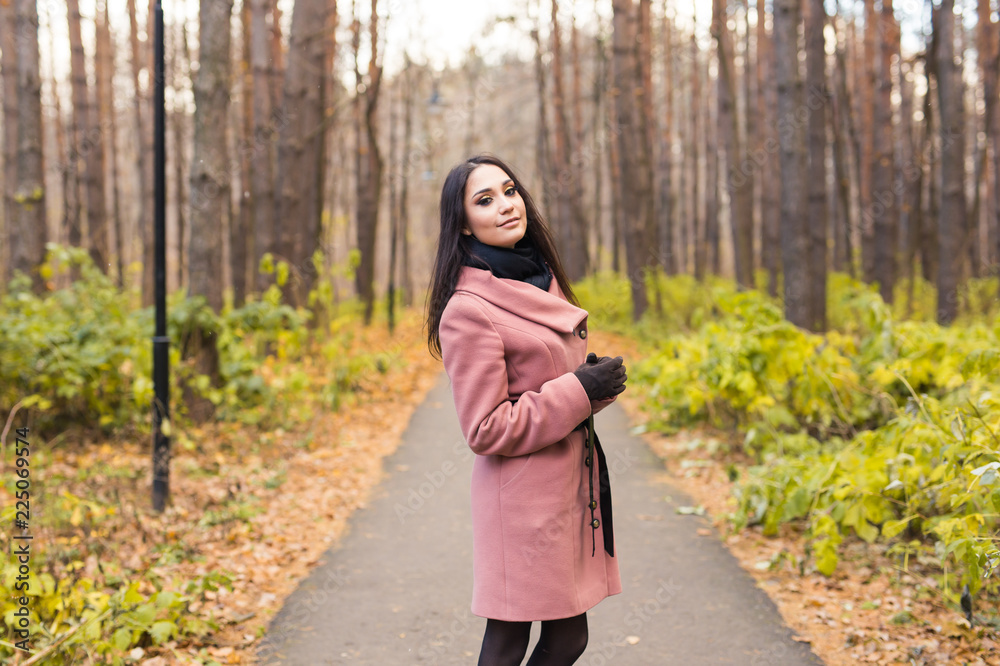 Young pretty woman in autumn park. Fall and season concept Young pretty woman in autumn park. Fall and season concept