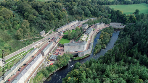 Aerial image of the village of New Lanark. A World Heritage Site in a deep valley next to the River Clyde.