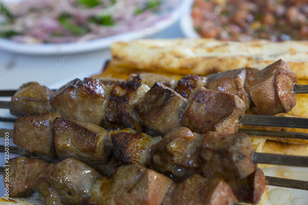 liver shish kebab on plate with bread