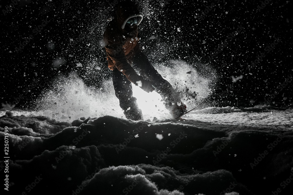 Active snowboarder in sportswear jumping on the board at night