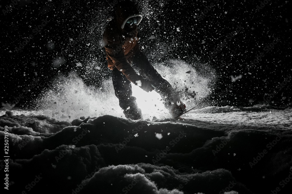 Obraz premium Active snowboarder in sportswear jumping on the board at night