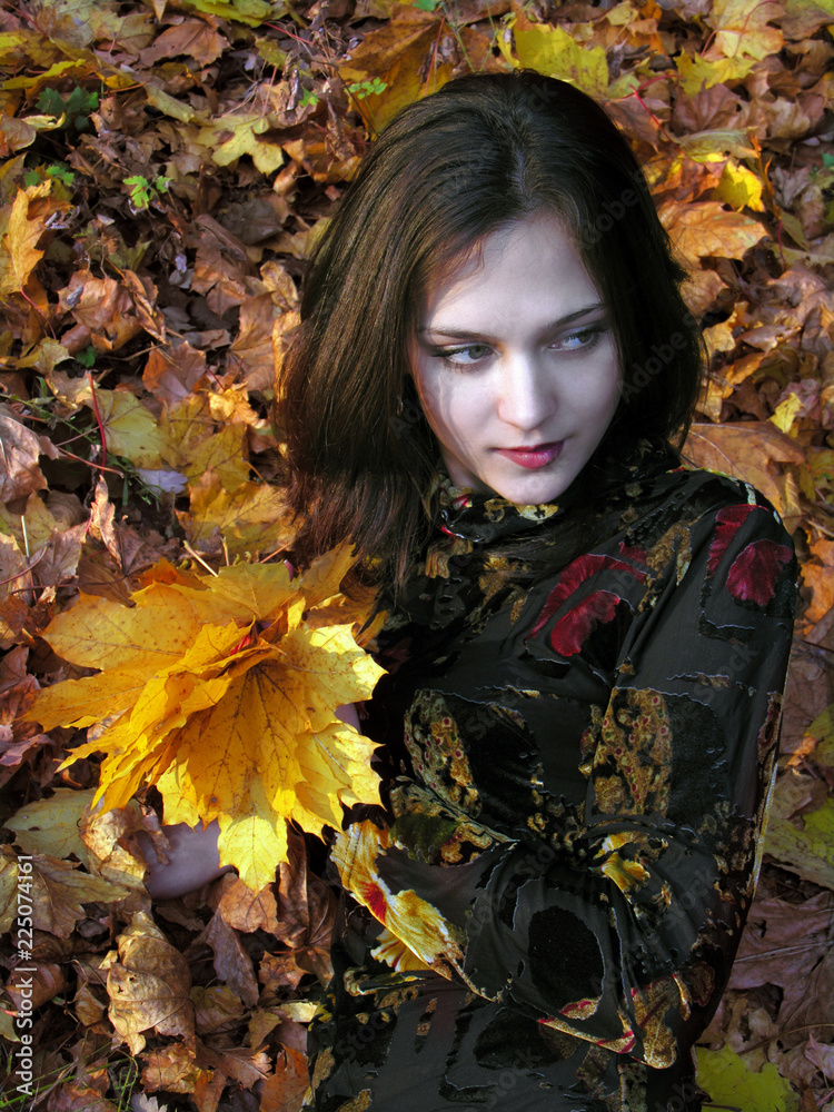 conceptual portrait of young attractive woman in the autumn park 