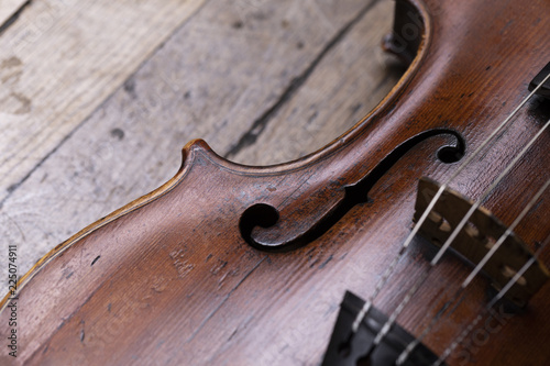 A part of a violin or a viola on a wood background
