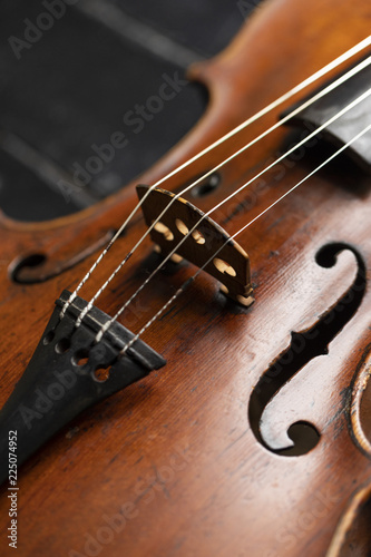 A part of a violin or a viola on a wood background