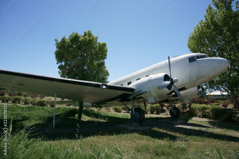 A cargo plane placed on a display stand on a grassy land