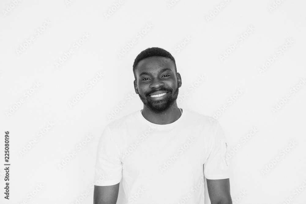 Single handsome muscular Black man with beard, folded arms and cheerful expression. black and white portrait Single handsome muscular Black man with beard, folded arms and cheerful expression. black and white portrait