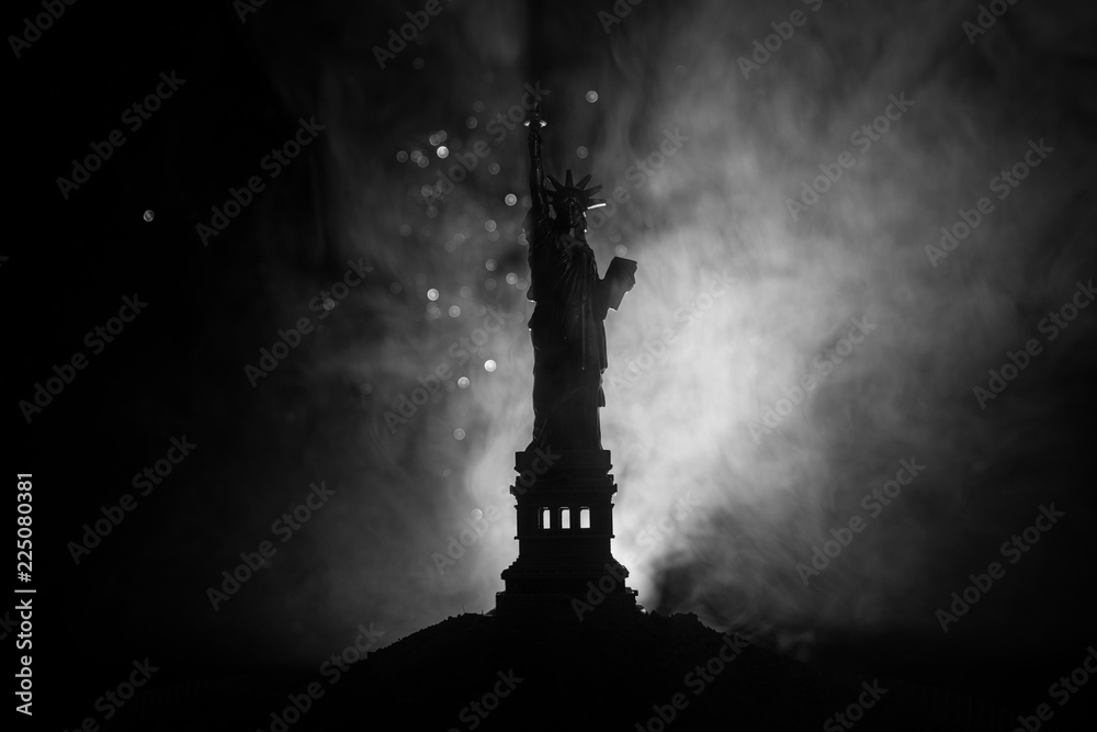 Silhouette statue of liberty on dark toned foggy background. Statue of Liberty on the background of colorful dawn sky Silhouette statue of liberty on dark toned foggy background. Statue of Liberty on the background of colorful dawn sky