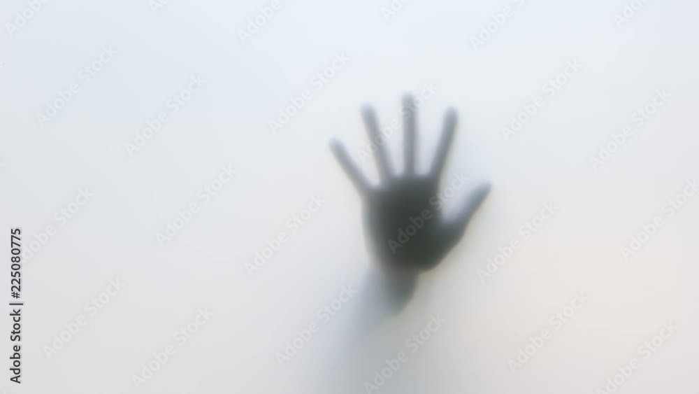 Close-Up of human hand on glass