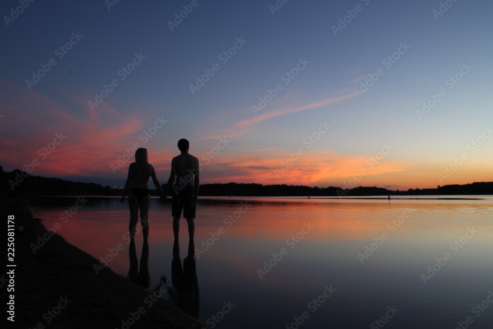 A romantic couple on a lake at sunset 