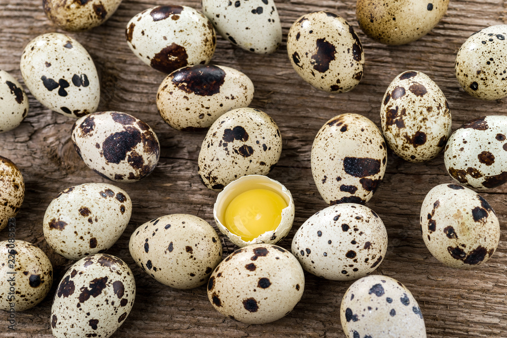 Quail eggs on a wood background. Yolk quail eggs without shell. Selective focus. Quail eggs on a wood background. Yolk quail eggs without shell. Selective focus.