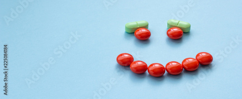 Smile of pills on a blue background, concept of health