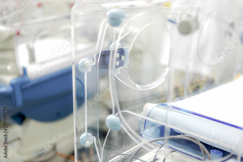 Newborn baby in hospital incubator.