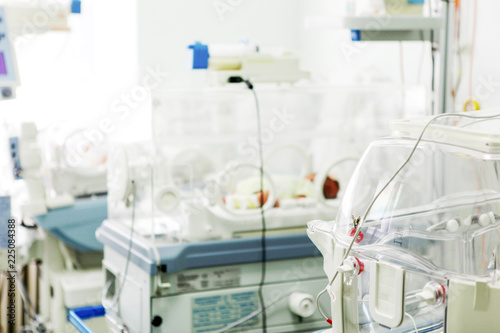 Newborn baby in hospital incubator.
