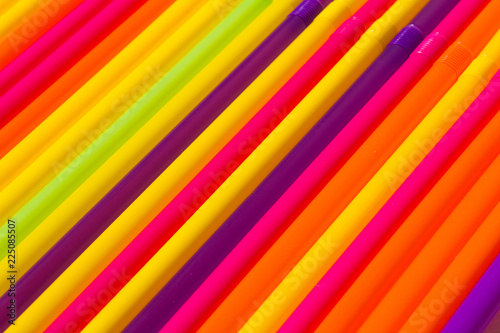 bright colorful drinking straws and tubes background. diagonal abstract pattern.