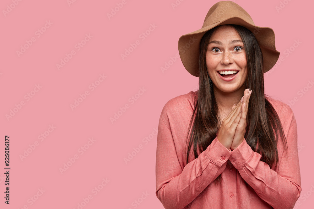 Photo of glad excited girlfriend with positive expression, dressed in fashionable outfit, smiles broadly, shows white teeth, isolated over pink background with copy space for your advertisement Photo of glad excited girlfriend with positive expression, dressed in fashionable outfit, smiles broadly, shows white teeth, isolated over pink background with copy space for your advertisement