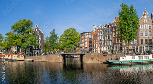 Buildings and boats along Amsterdam's beautiful  canals in central Amsterdam during the day. The canals are one of Amsterdam's main attractions.
