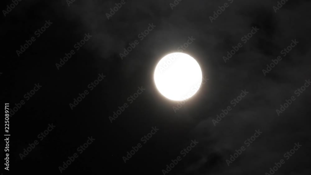 Full Moon in a cloudy night sky with clouds moving around. Close up 4k video Full Moon in a cloudy night sky with clouds moving around. Close up 4k video