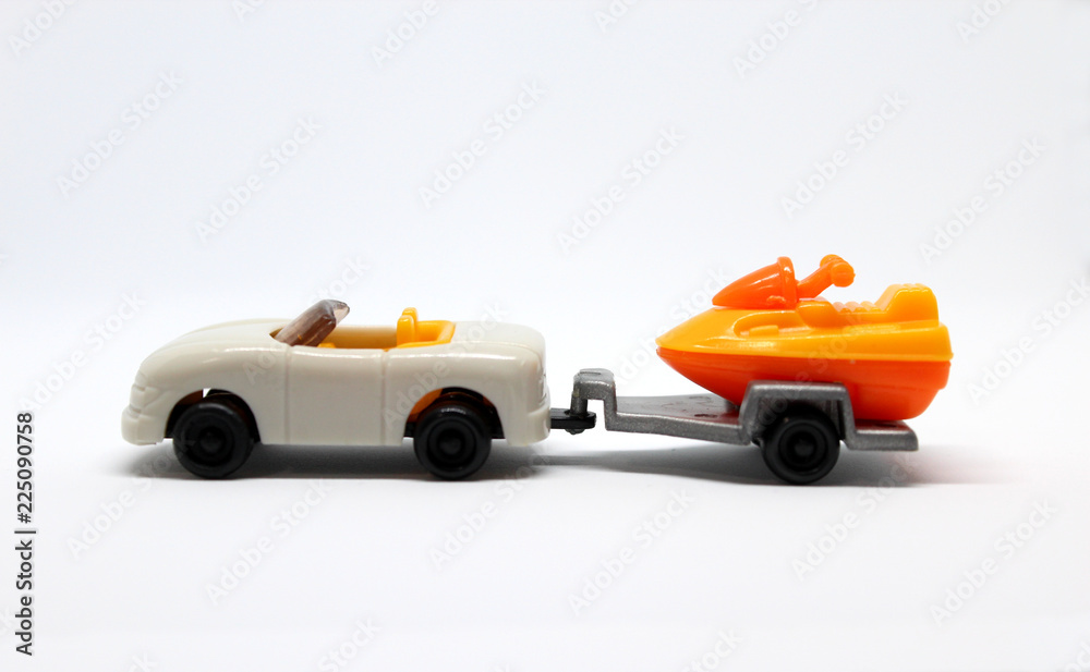 Isolated White Toy Car With Trailer Which Carrying Jetski On It Isolated White Toy Car With Trailer Which Carrying Jetski On It