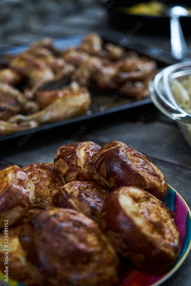 Party snack food table with baked potatoes, fried chicken drumsticks, italian pasta and puff pastry buns bread, close-up. Table with variety food top view. Party snack food table with baked potatoes, fried chicken drumsticks, italian pasta and puff pastry buns bread, close-up. Table with variety food top view.