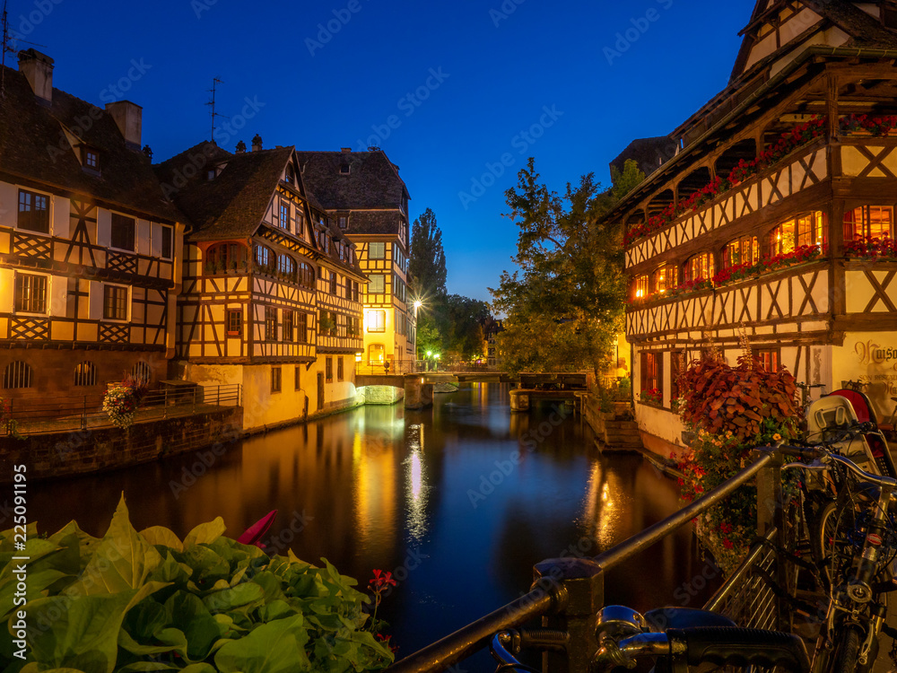Naklejka premium Sunset along the Ill River in Petite France areas of Strasbourg in the Alsace region of France.