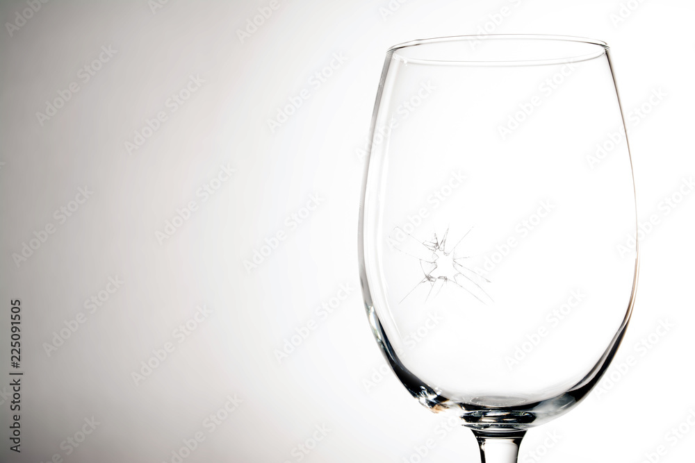 Broken wine glass on a grey background