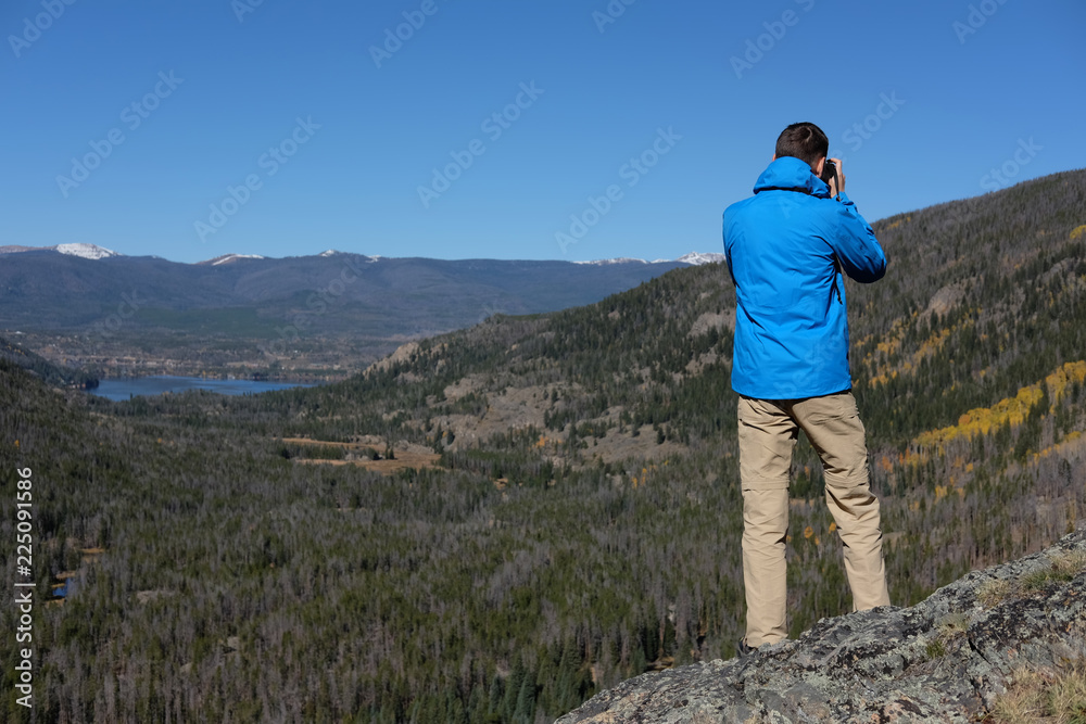 Hiker tourist taking photo