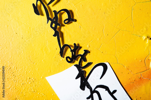 Cut Japanese A to Z characters on yellow grunge background