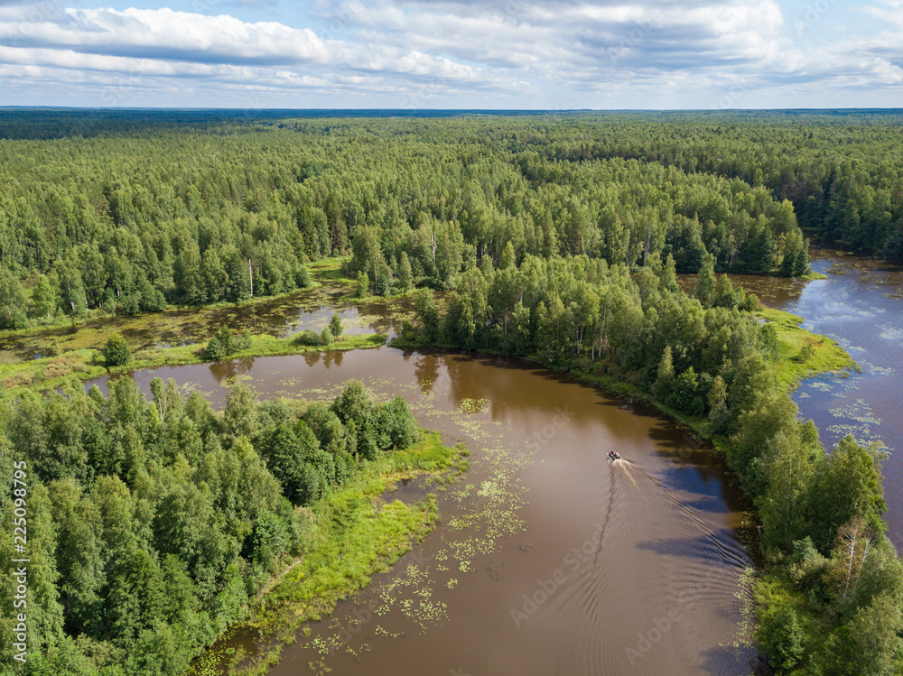 Aerial view of river Nemda with green riverside and boat. Summer 2018, Russia Aerial view of river Nemda with green riverside and boat. Summer 2018, Russia