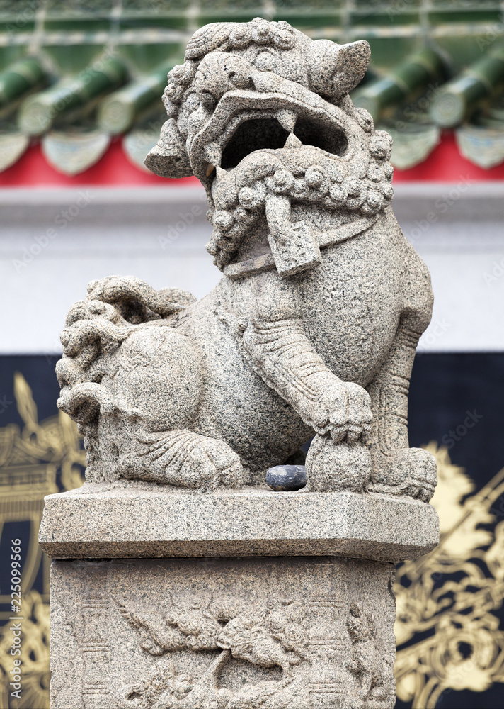 Chinese lion at the entrance of a temple Chinese lion at the entrance of a temple