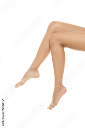 beautiful female legs isolated on white. Perfect skin tone.