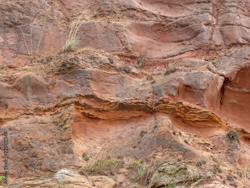 Erosion in the red sandstone coastal cliffs at Budleigh Salterton, Devon, UK. Geology on the Jurassic coast. © Mushy