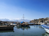 Boats in Antalya harbor over clear sky