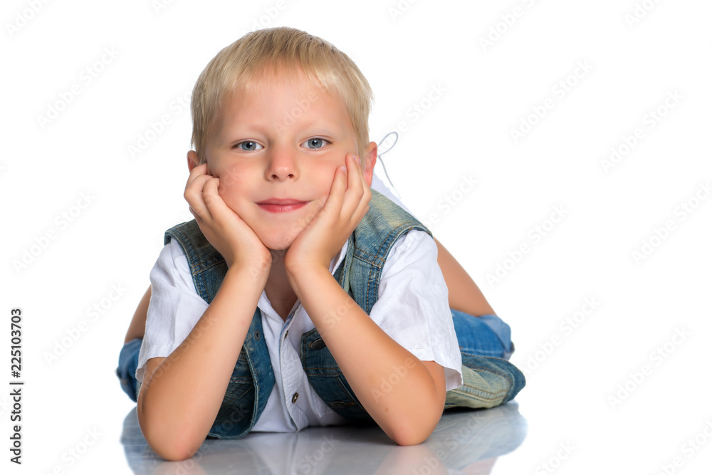 A little boy is lying on the floor in the studio. A little boy is lying on the floor in the studio.