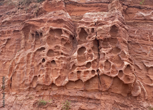 Erosion in the red sandstone coastal cliffs at Budleigh Salterton, Devon, UK. Geology on the Jurassic coast.